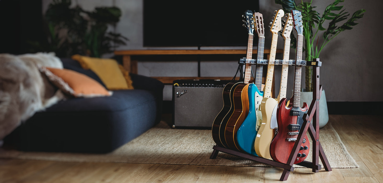 Rhythm & Timbre AltaTrack Guitar Stand in a modern lounge setting